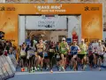 Zawodnicy przekraczają linię startu Maratonu Cracovia. Tłum kibiców z telefonami dokumentuje to wydarzenie.